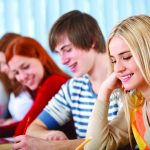 Group of college students studying in classroom